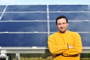 Man in front of solar panel